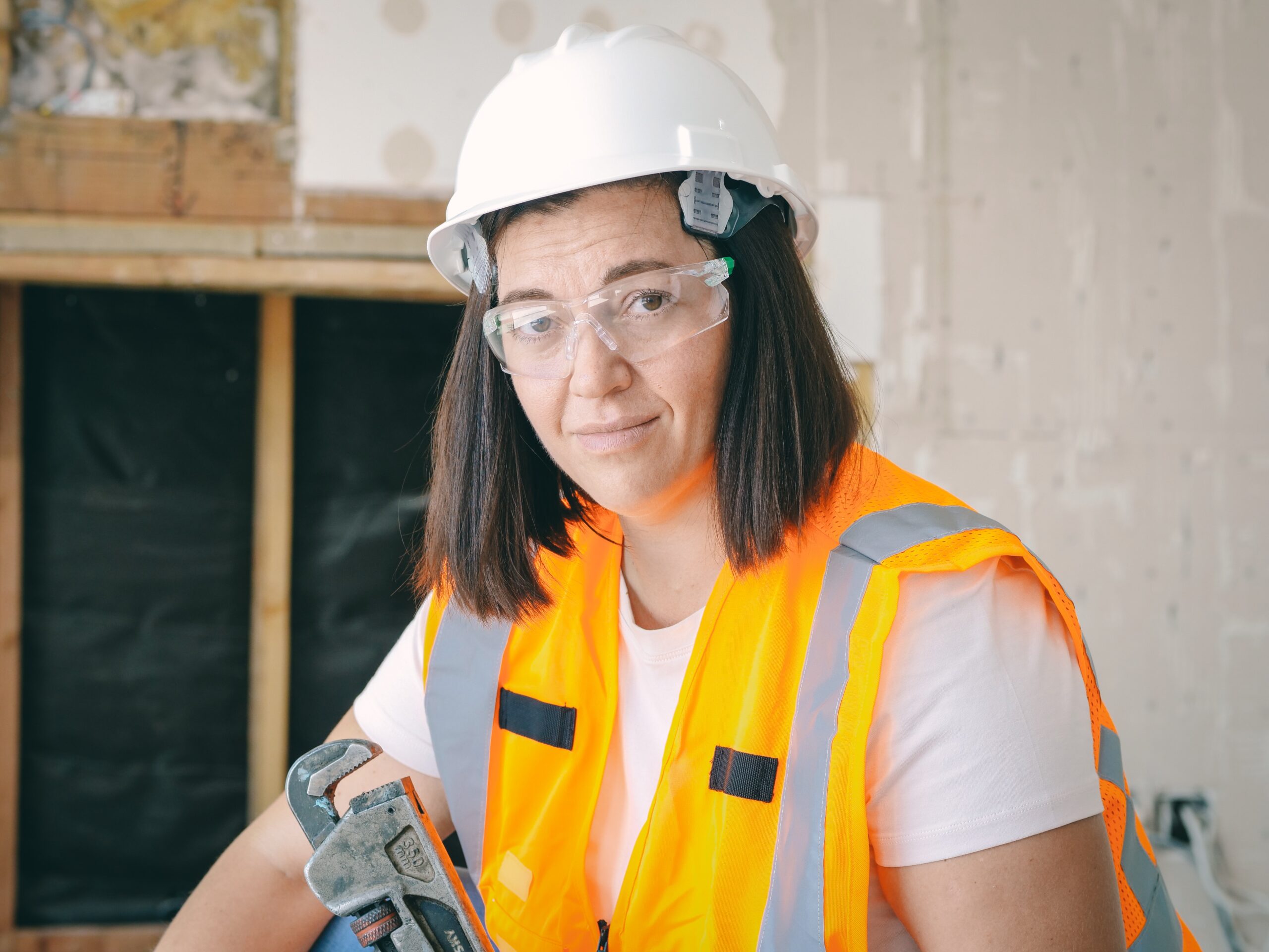 handywoman-holding-a-plumbers-wrench