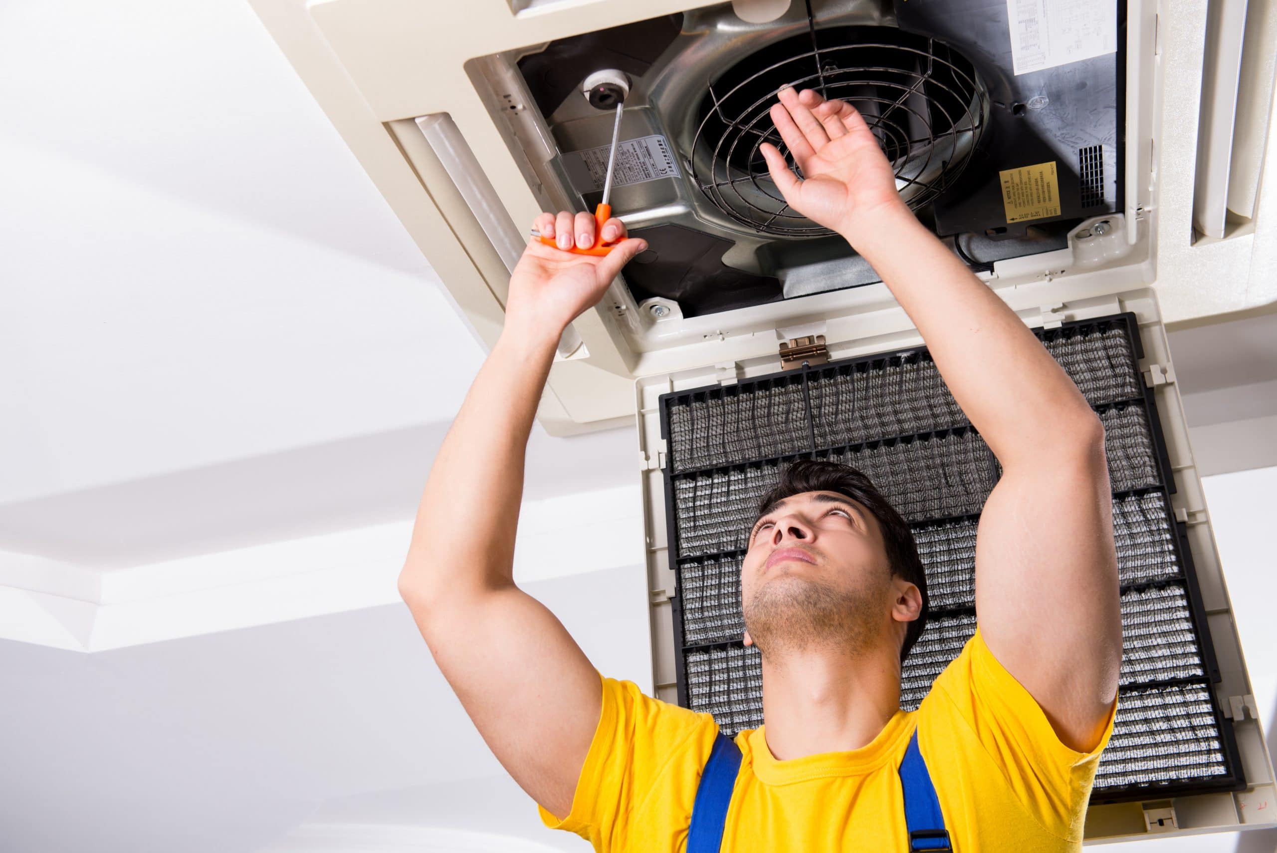 hvac technician fixing an AC